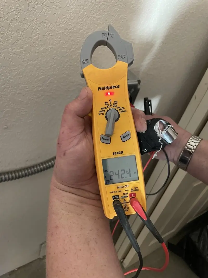 Voltage testing with clamp meter during Recessed Lighting Installation in Nassau Village-Ratliff